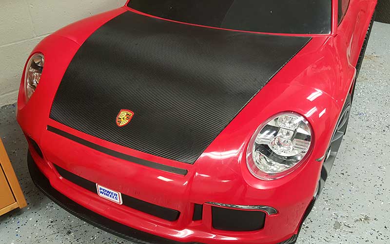 Custom Graphic Wrap Design on a Red Porsche Power Wheels by Premier Auto Tint in El Dorado Hills, CA 95762.